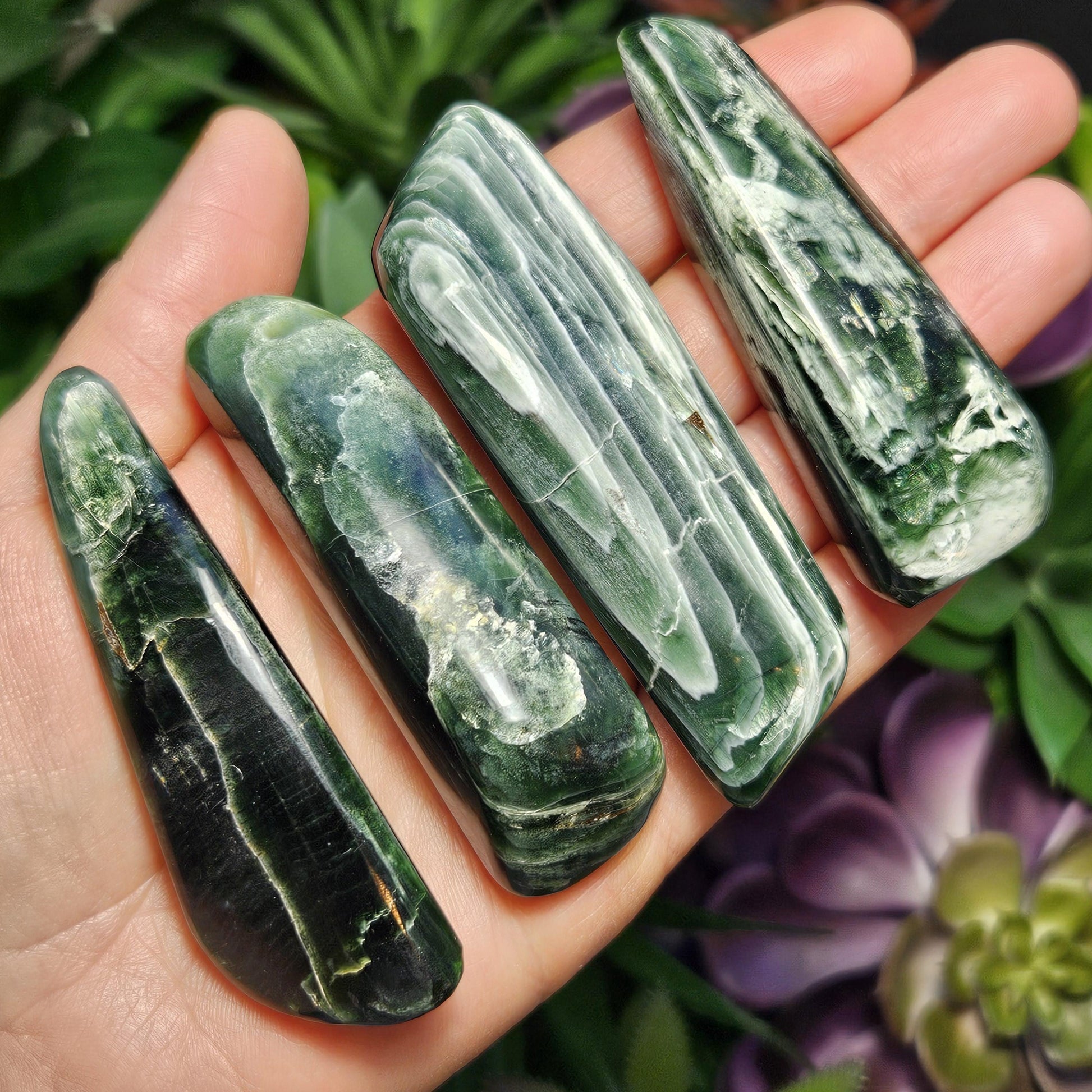 May include: Five polished green and white ocean jasper tumbled stones.  The stones are various shapes and sizes, showing swirling patterns of dark and light green with white veining.  These polished stones are ideal for metaphysical healing, reiki, and other energy work.