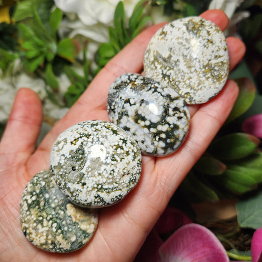 May include: Four green and white ocean jasper stones, each with a different pattern of white spots and green veins.